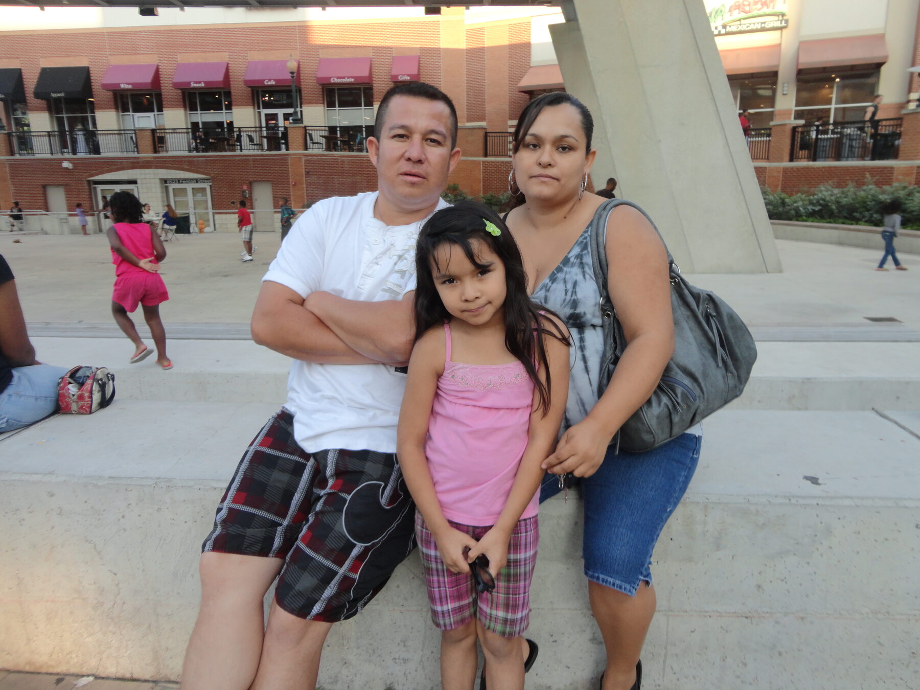 Homero posing outdoors with family