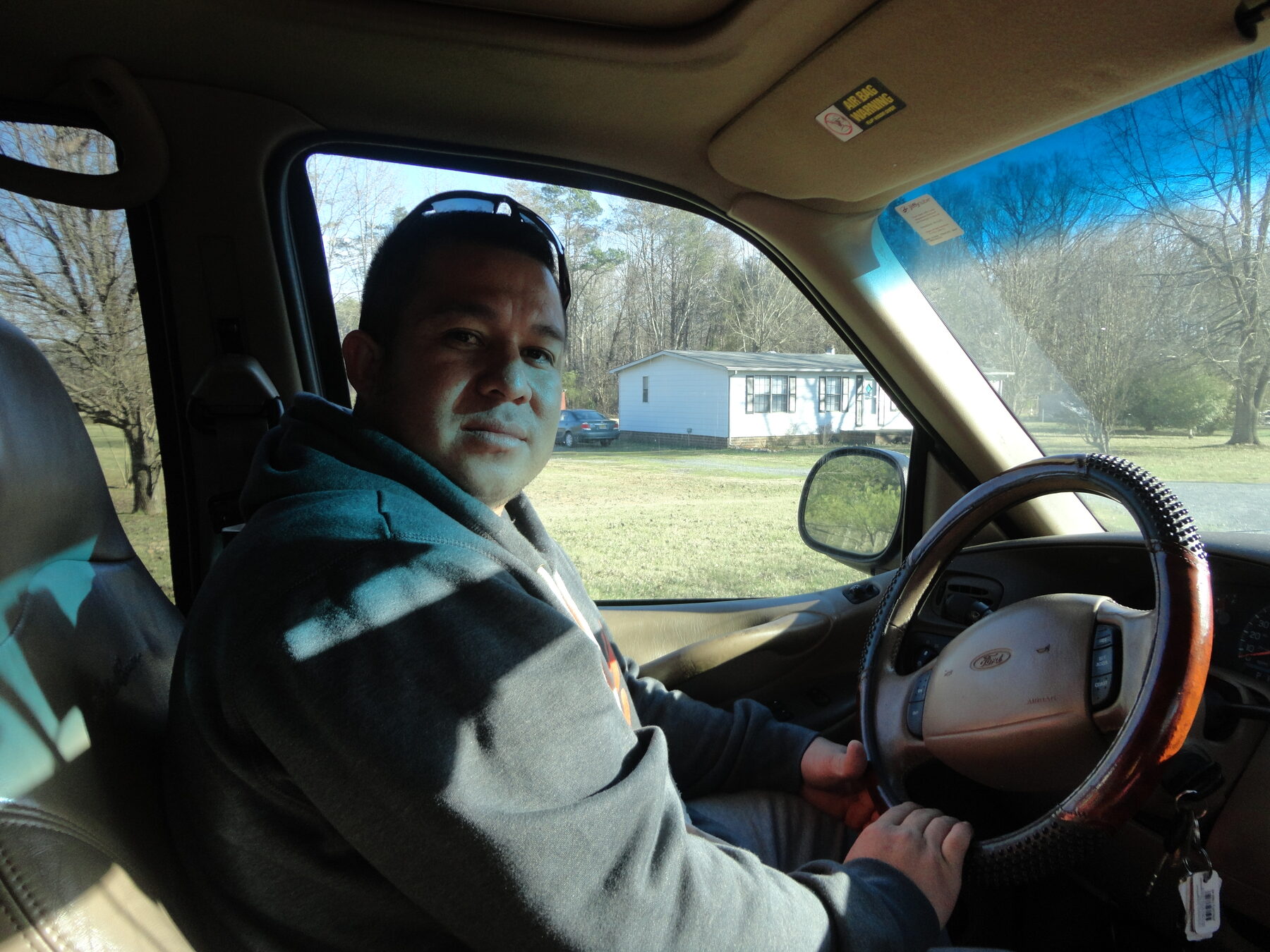 Homero sitting in the driver's seat of a vehicle