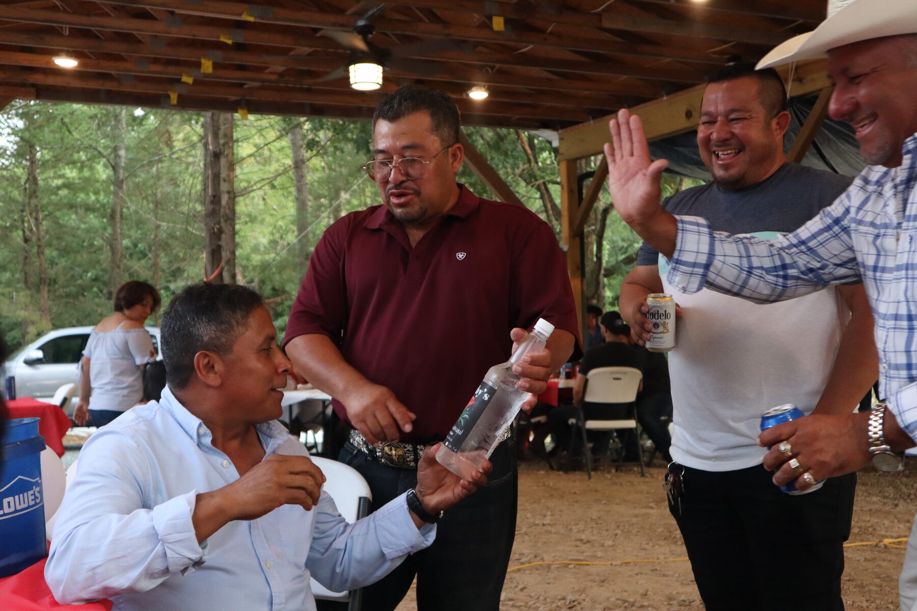 Homero laughing with friends at an outdoor gathering