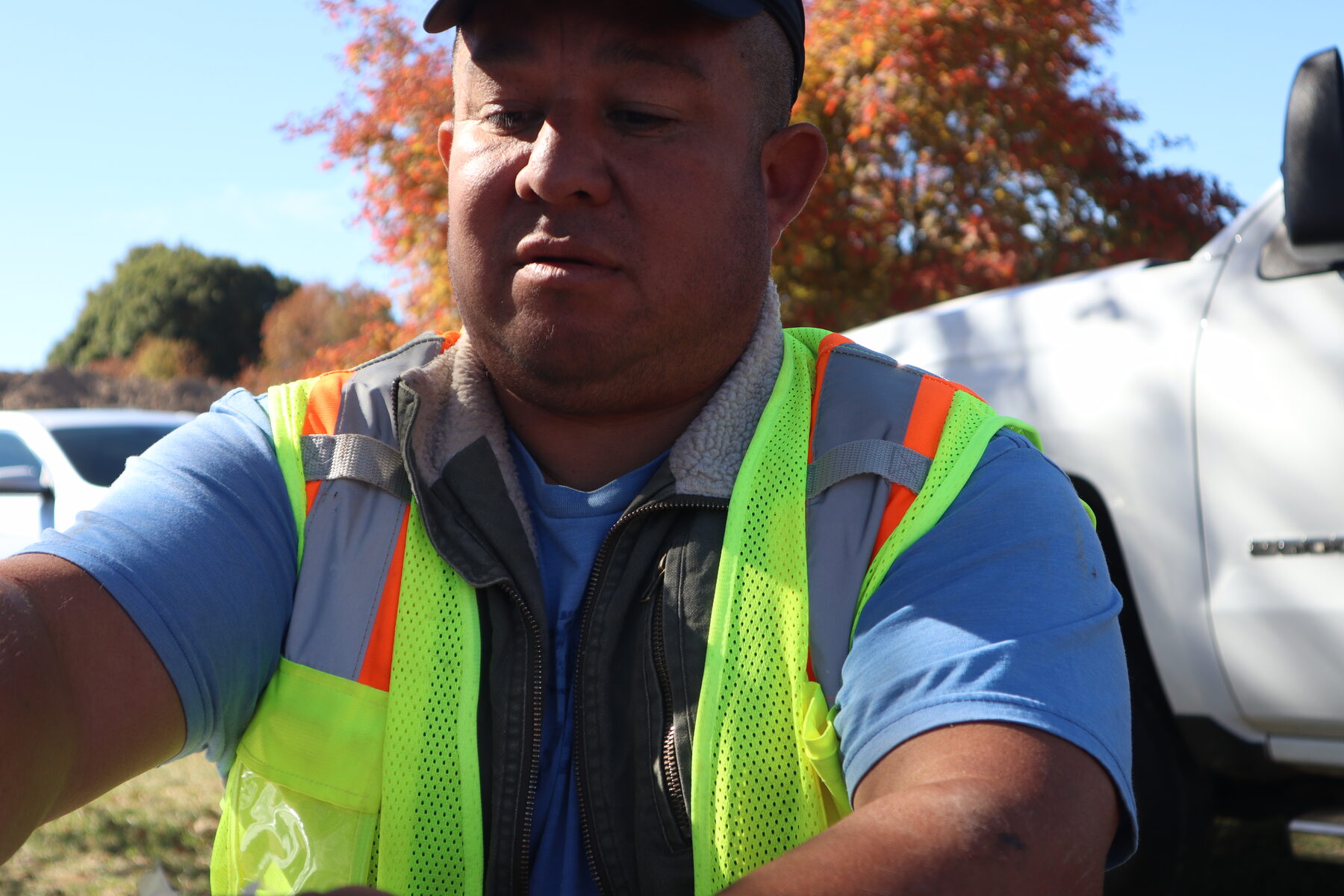 Homero wearing a high-visibility vest at a work site
