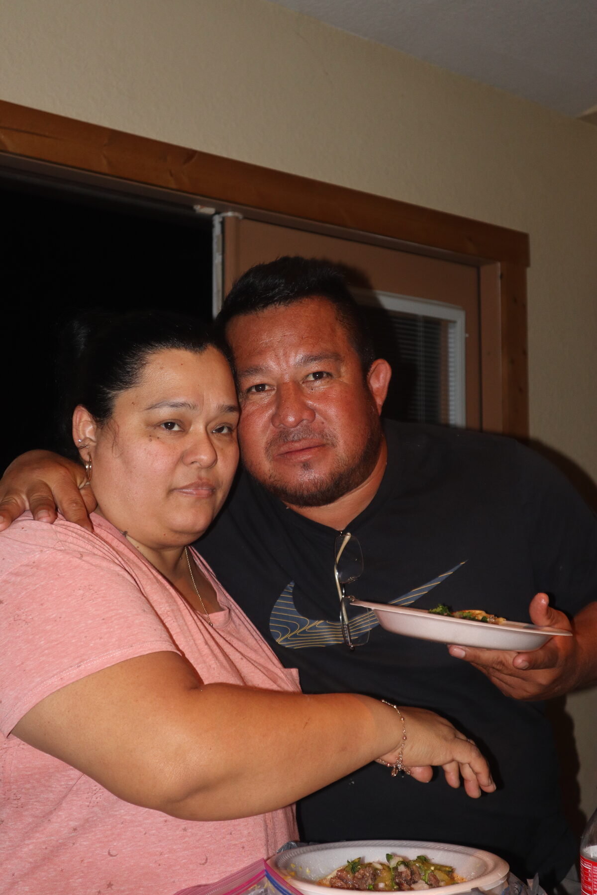 Homero sitting closely with family at a table