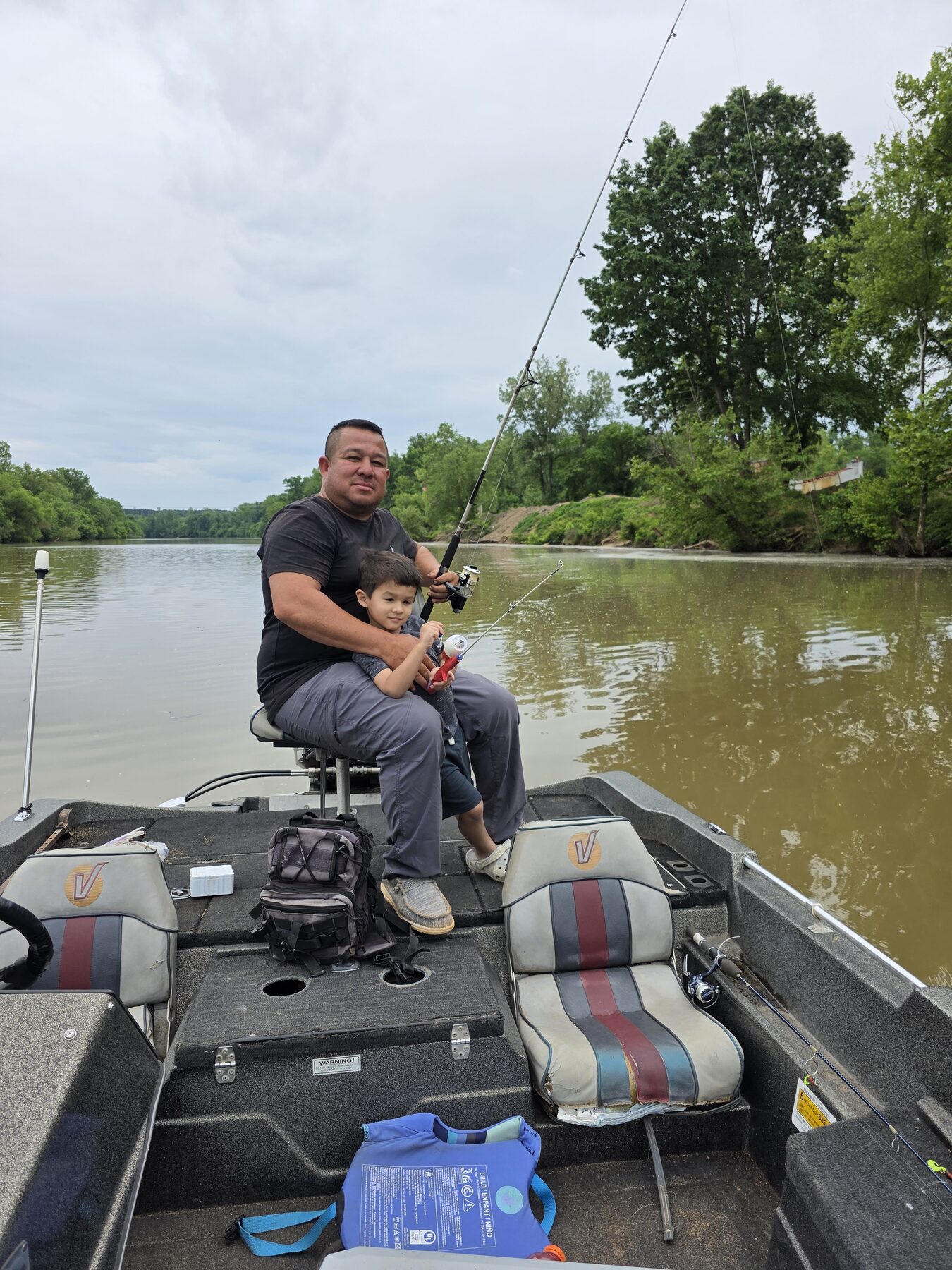 Homero fishing from a small boat
