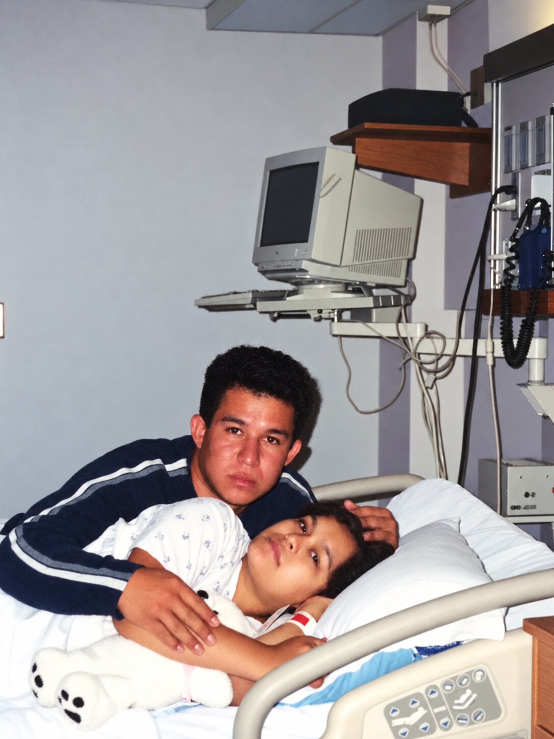 My dad holding my mom in the hospital after she gave birth to me