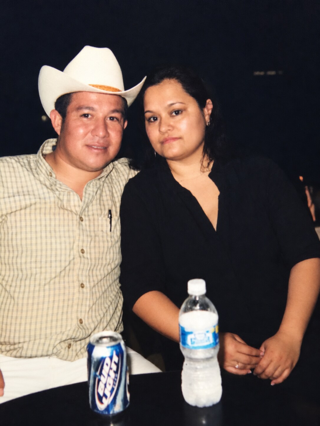 My dad in a cowboy hat beside my mom at a gathering