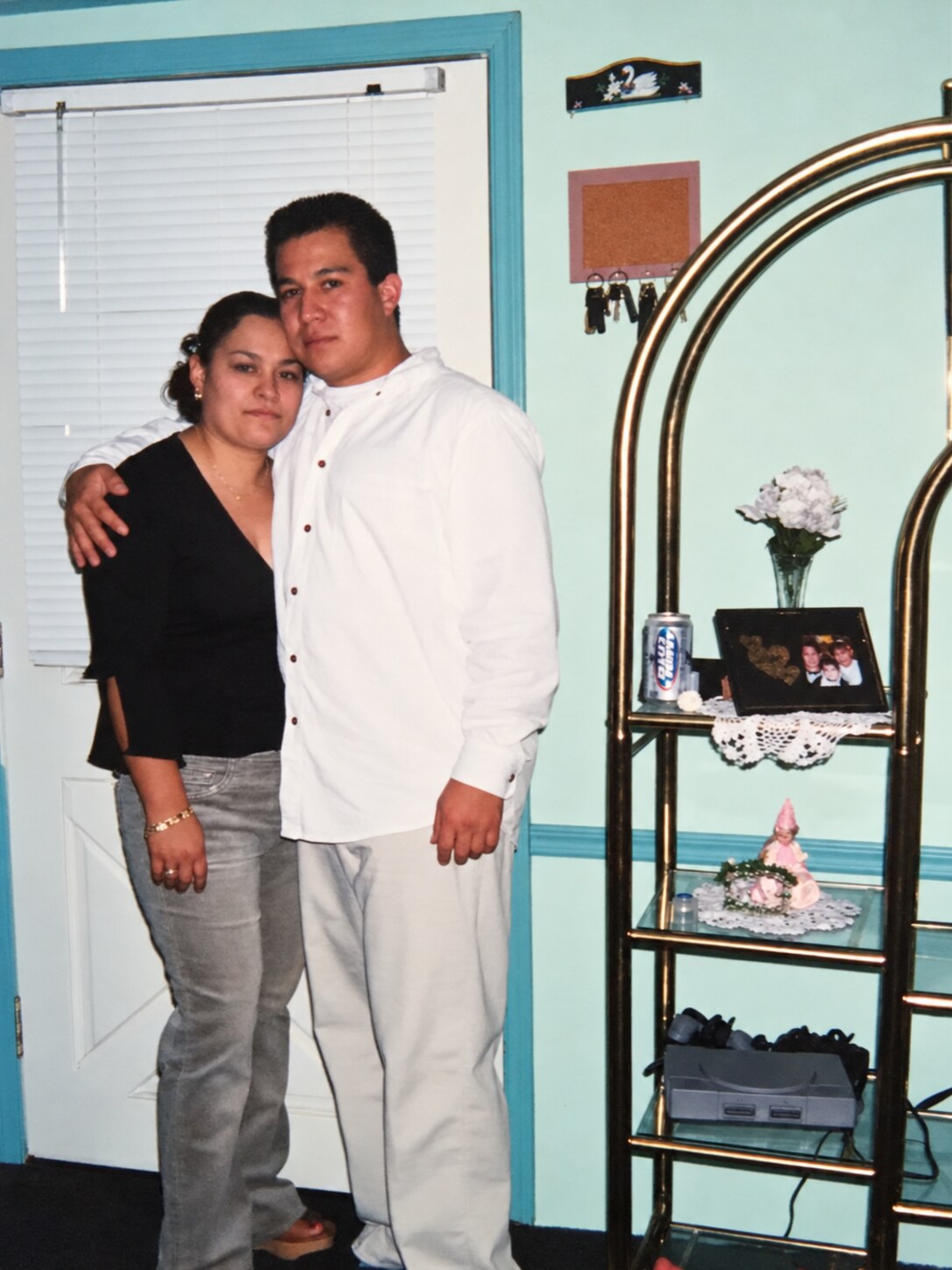 My dad and my mom posing together inside a home