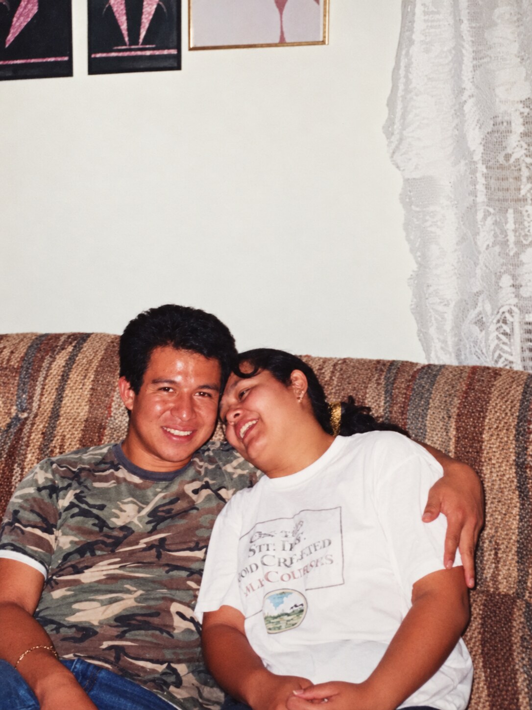 My dad and my mom laughing together on a couch