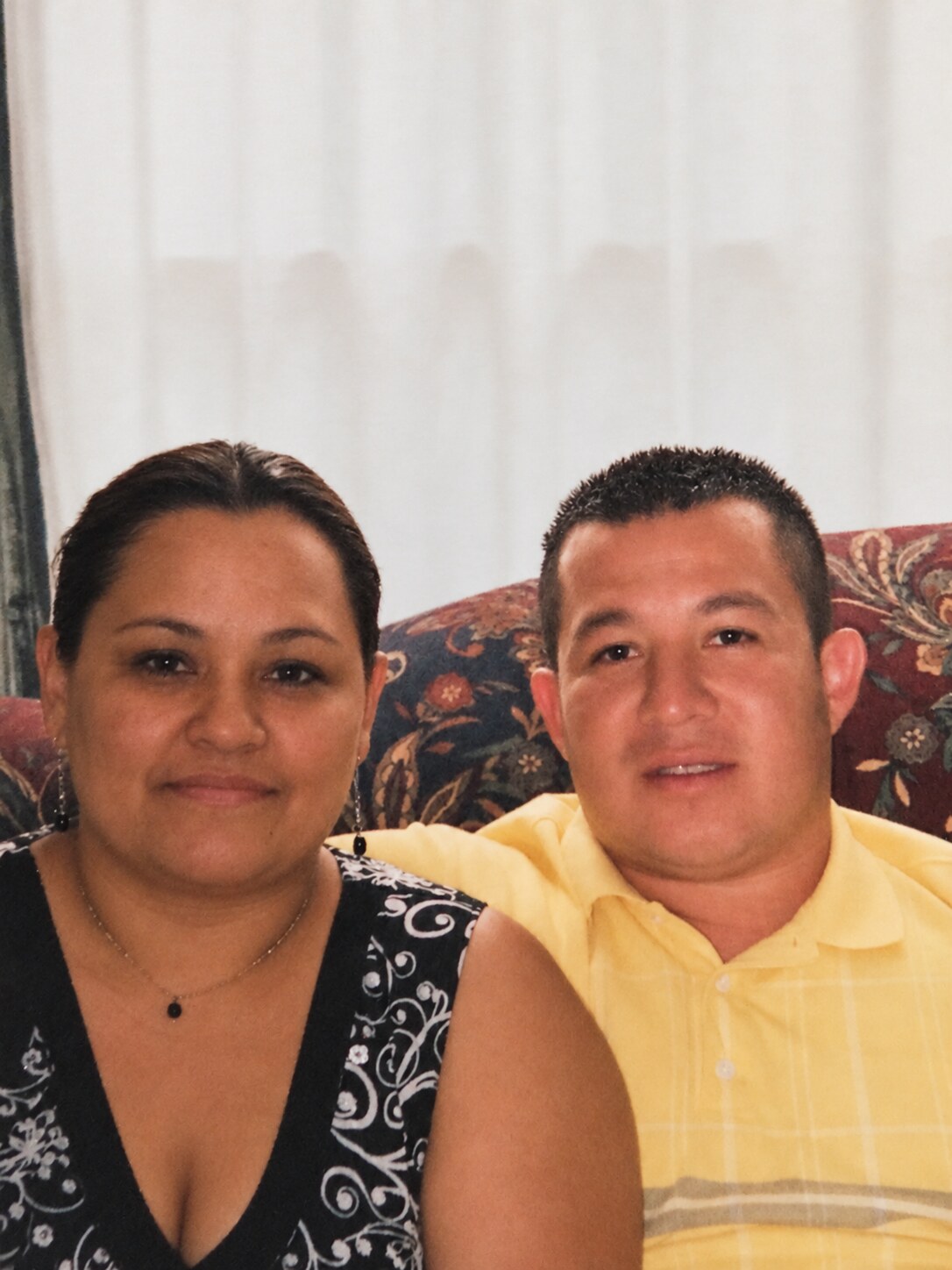 My dad and my mom sitting together on a couch