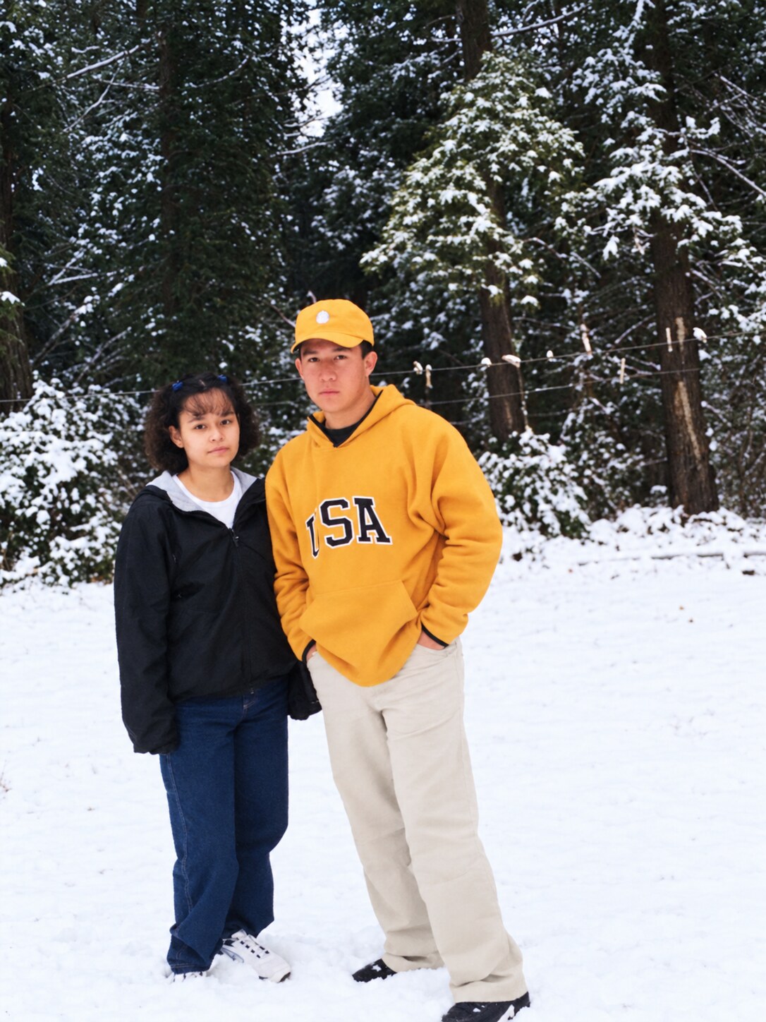 My dad and my mom standing together in the snow