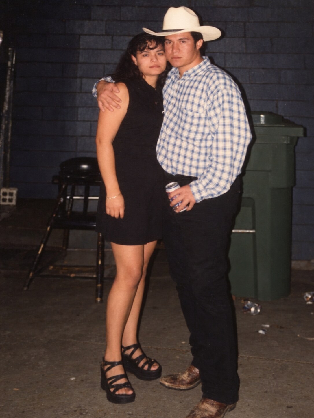 My dad in a cowboy hat beside my mom at night